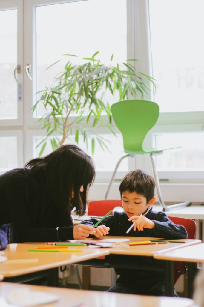 a woman and a child sitting at a table